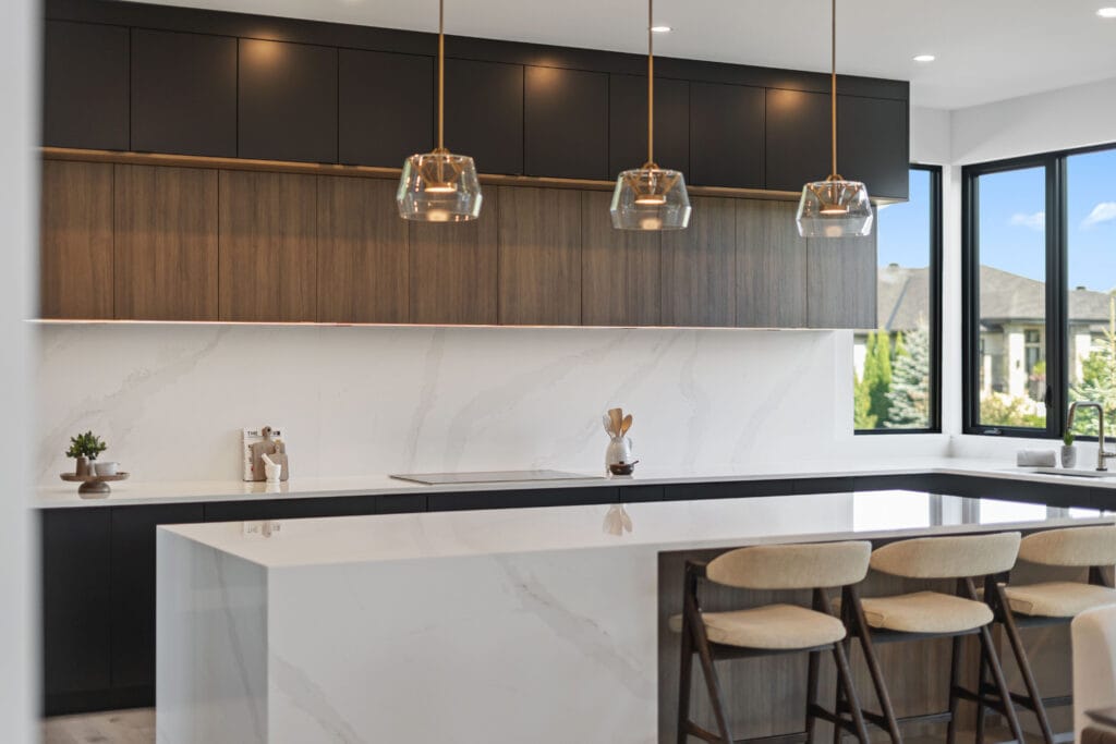 Sophisticated kitchen from Stone Design Concepts portfolio Bespoke Developments Dunblane Project with a large white marble island, pendant lighting, and wood-accented cabinetry.