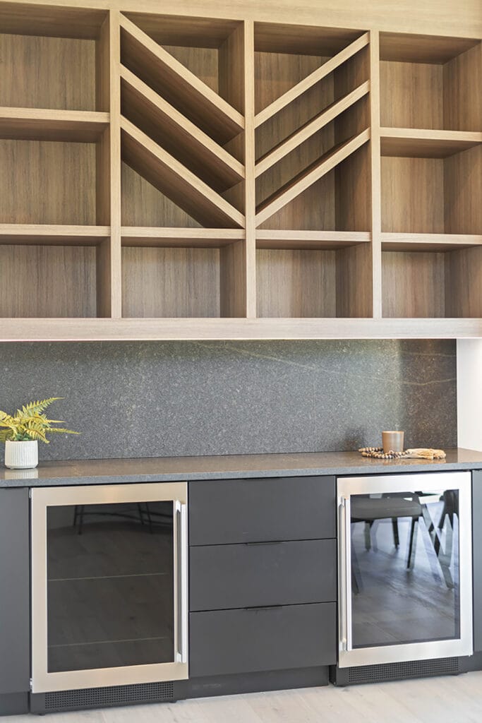Custom cabinetry from Stone Design Concepts portfolio Bespoke Developments Dunblane Project, featuring natural wood shelving and dark granite countertop with stainless wine coolers