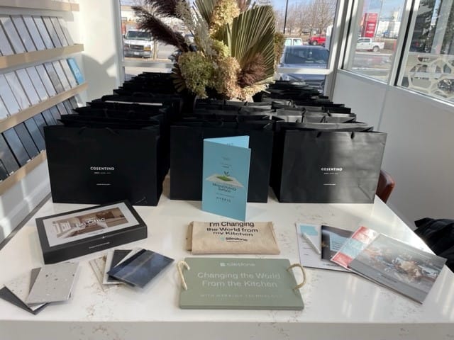 Gift bags and promotional materials displayed at the Cosentino event Stone Design Concepts, showcasing sample stones and event-branded items.
