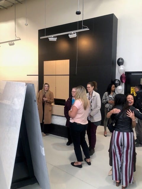 Attendees mingling at the Hanstone colour launch event, surrounded by modern decor and balloon arrangements in a bright, spacious showroom.