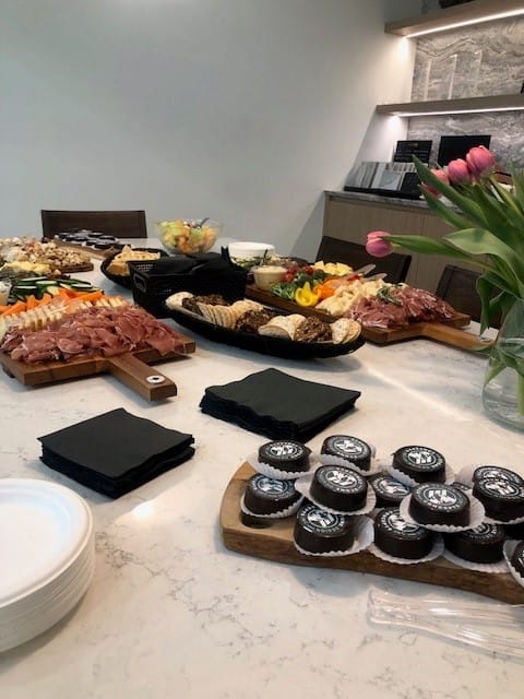 Elegant food spread at the Hanstone colour launch event, featuring assorted charcuterie, desserts, and floral arrangements on a Hanstone countertop.