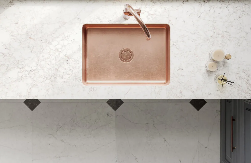 Elegant countertop design from Stone Design Concepts Gallery featuring a marbled white surface, with minimalistic decor accents.