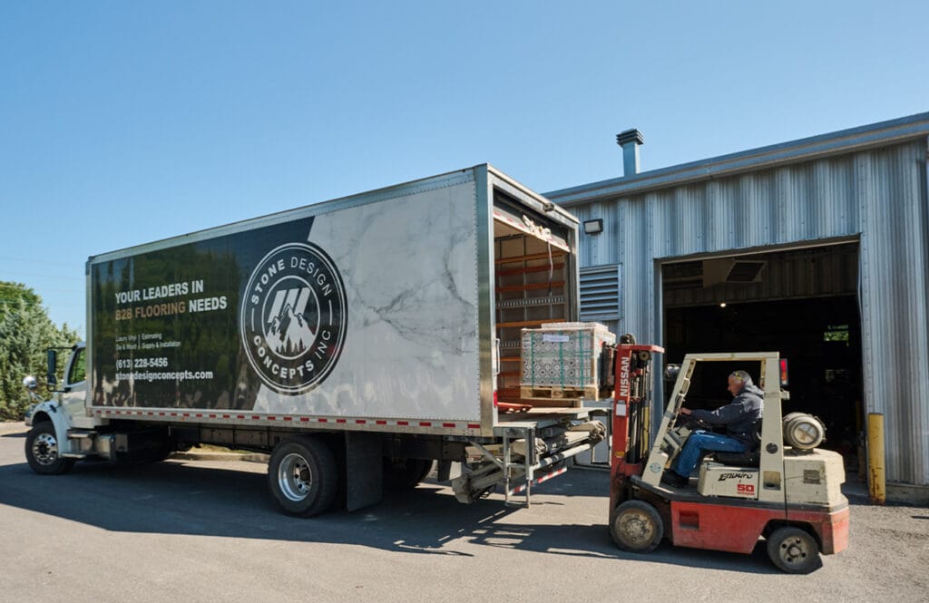 Stone Design Concepts truck processing a delivery